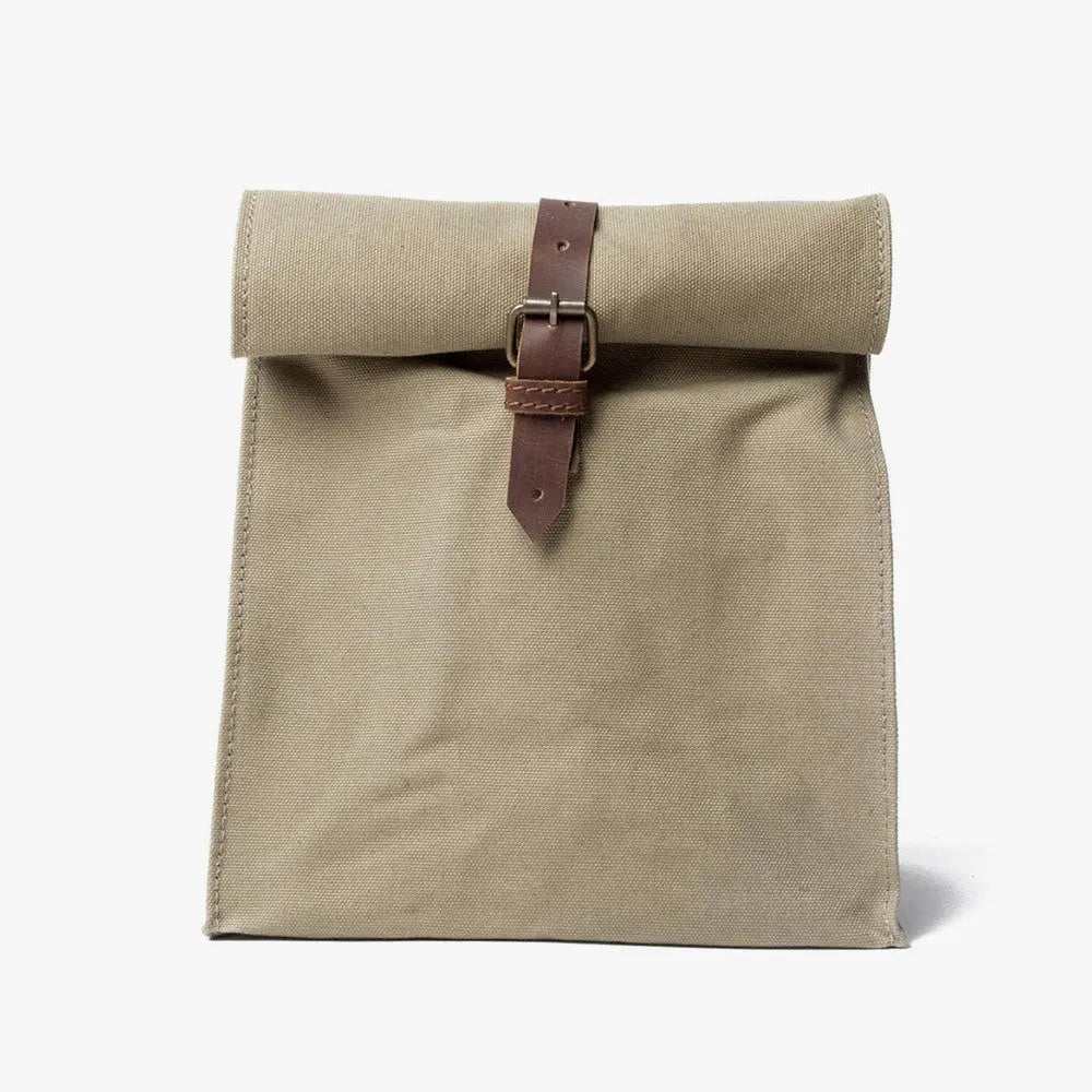 Canvas lunch bag made of 100% organic cotton with leather trim and roll-down snap closure
