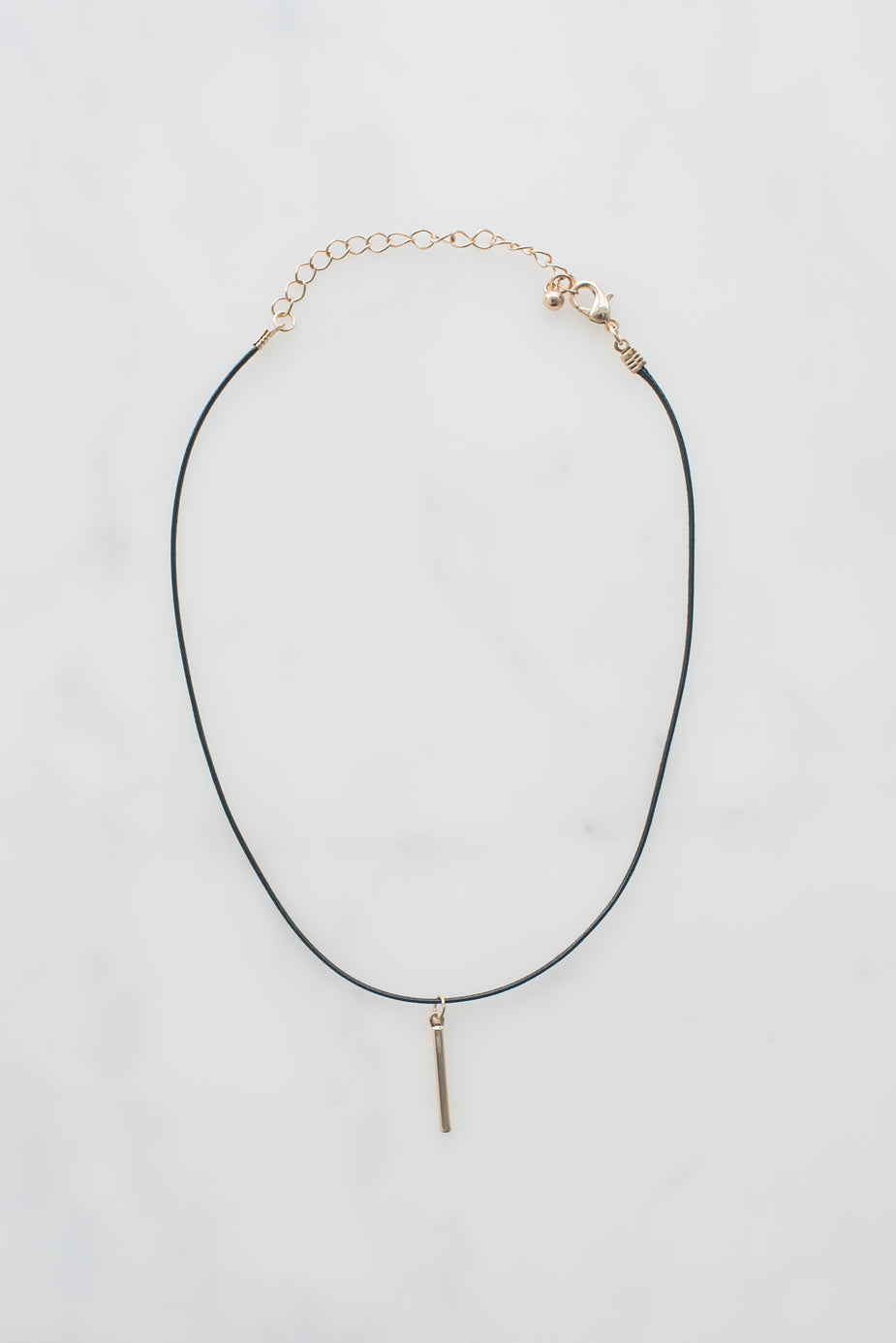 Black leather choker necklace with 14k yellow gold pendant and lobster clasp, made in USA.