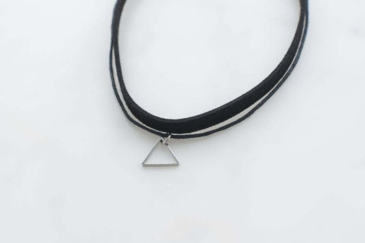 Black choker with silver triangle pendant on a white background