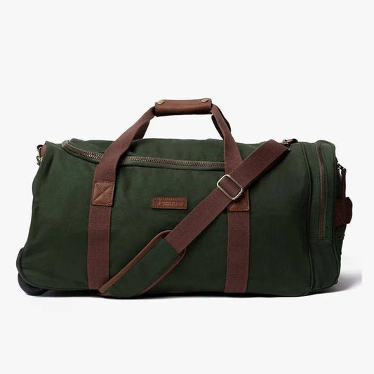 Dawson Trolley duffle bag with leather trim, brass hardware, collapsible handle, and removable strap made from organic canvas.