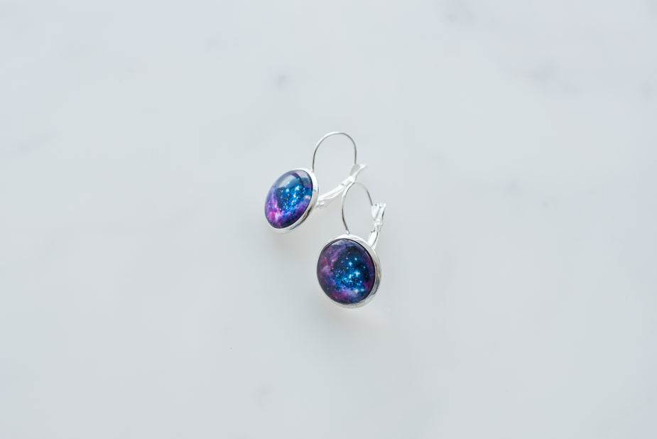 Galaxy earrings with sterling silver clasps on white background