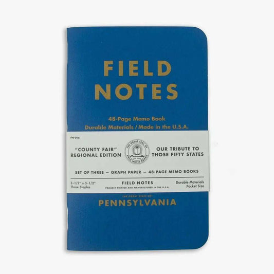 Three Pennsylvania Notebooks with linen covers and metallic gold printing in blue, red, and yellow colors featuring state facts